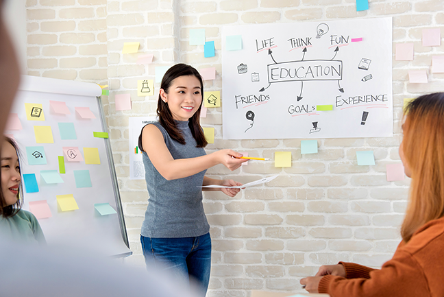Asian female college student making a presentation in classroom